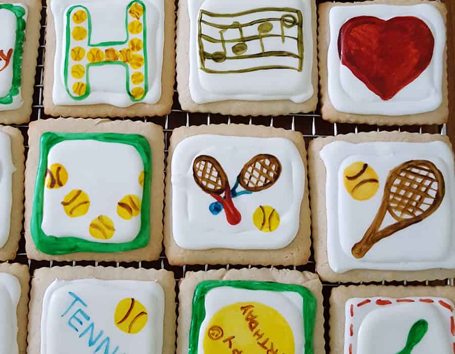 and assortment of hand painted sugar cookies with different designs on them.